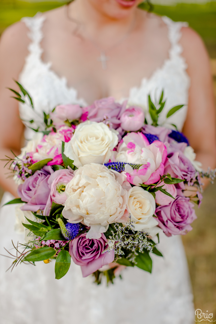 purple and white bridal bouquet with roses and peonies