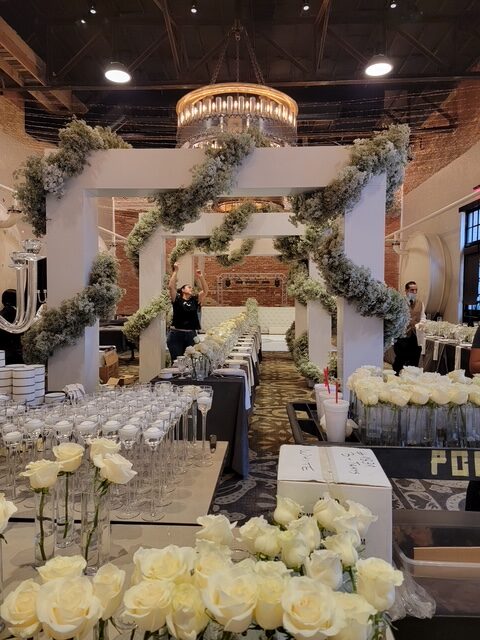 large arches draped with flower garlands for wedding reception