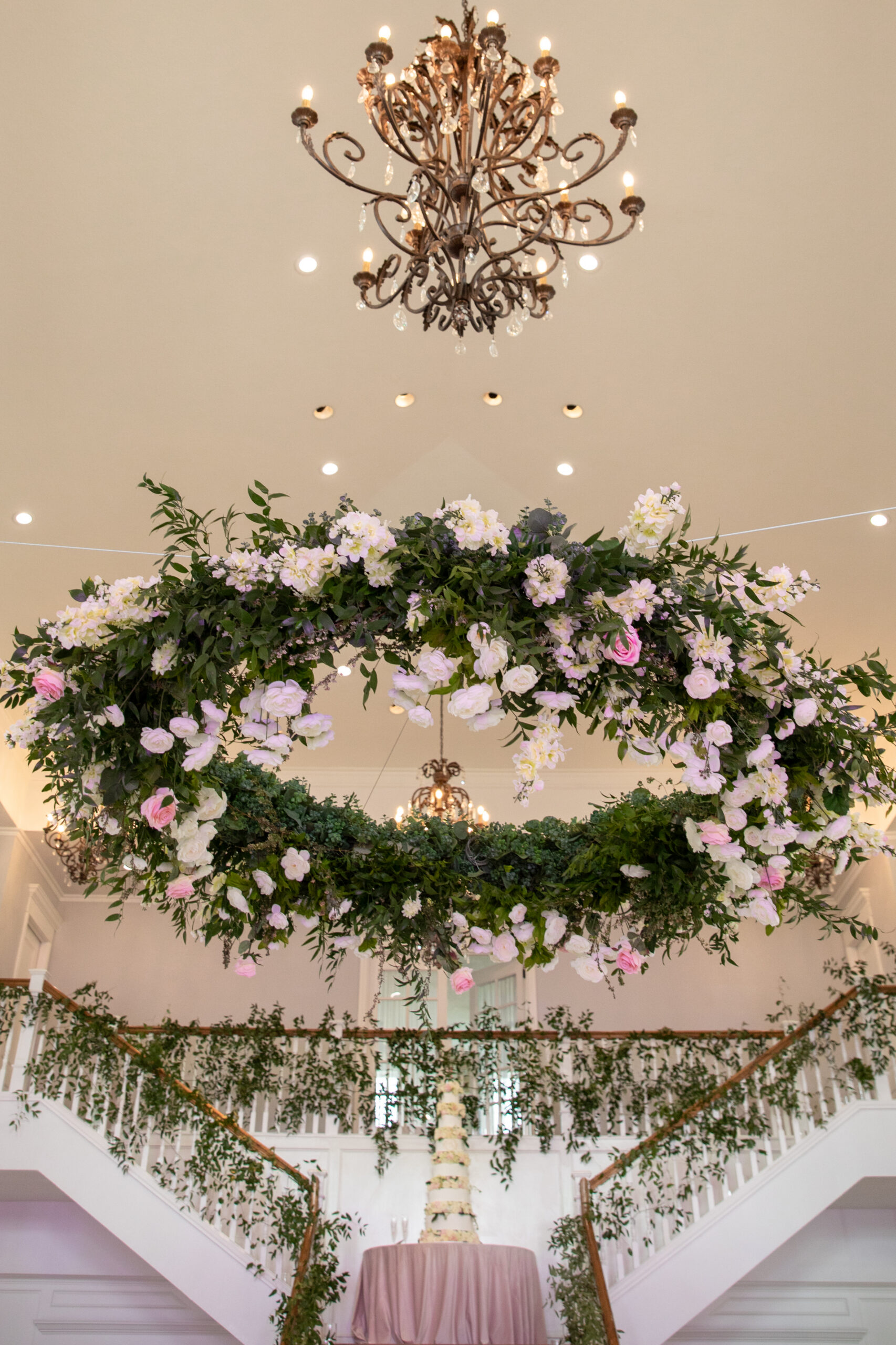 large hanging floral arrangement over stair well