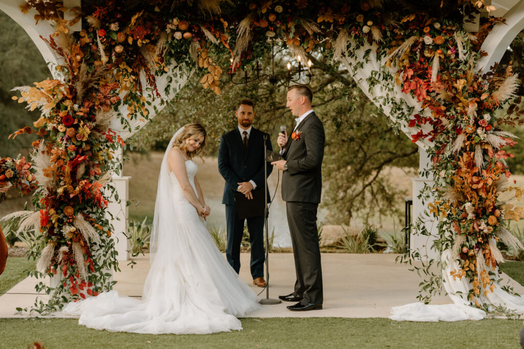 wedding arch covered in fall themed flowers