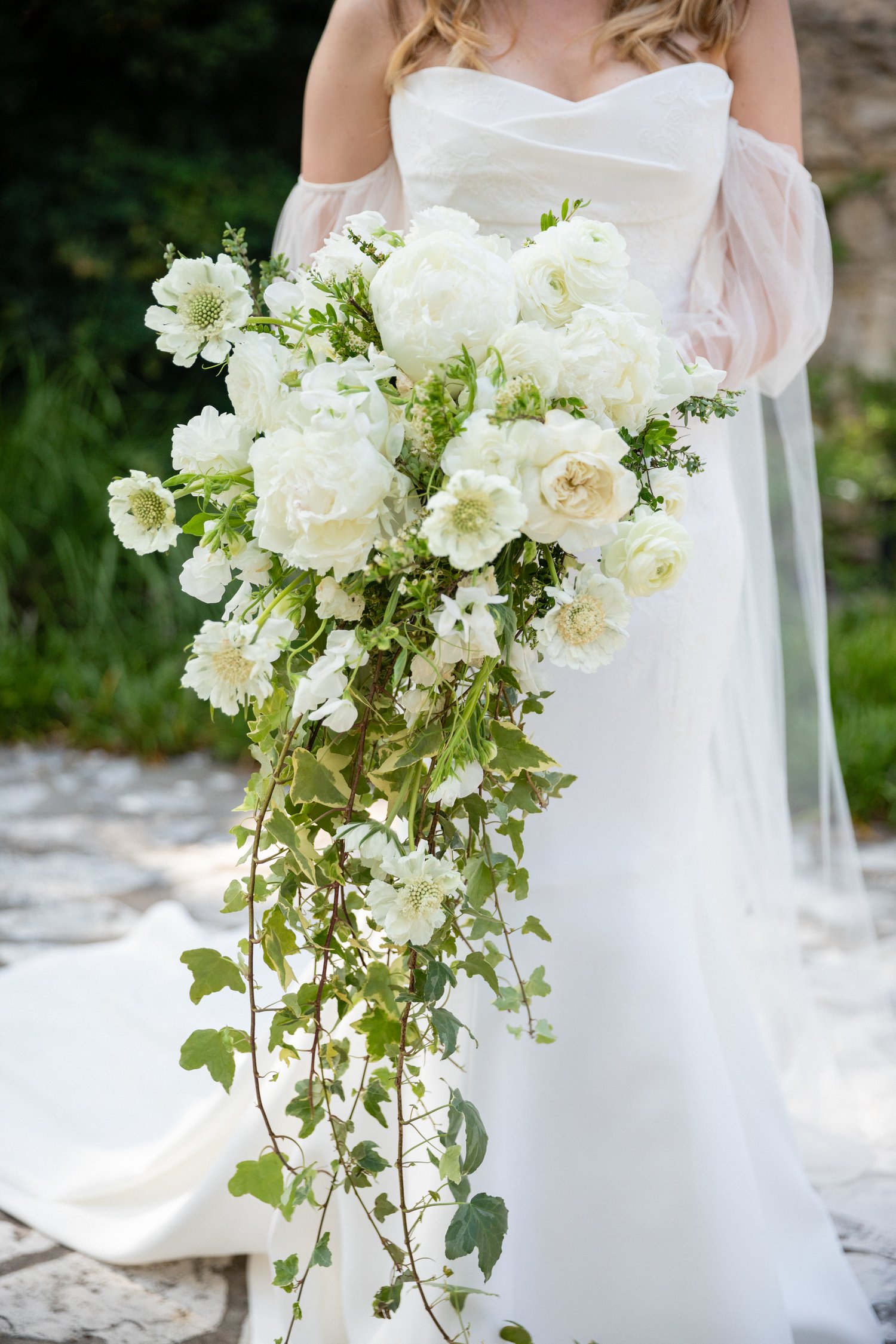 large white bridal bouquet with trailing greenery